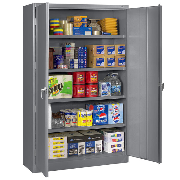 A dark gray Tennsco storage cabinet full of items.