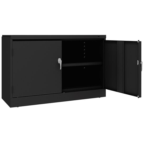 A black Tennsco metal storage cabinet with open doors.