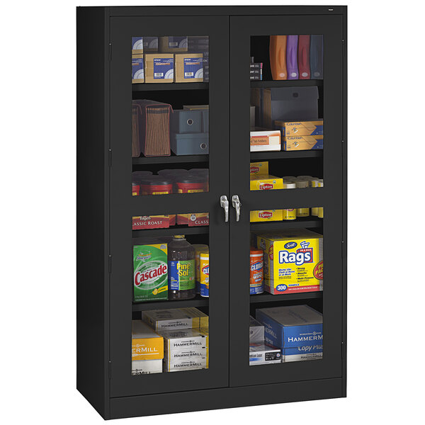 A black Tennsco storage cabinet with C-Thru doors filled with various items.