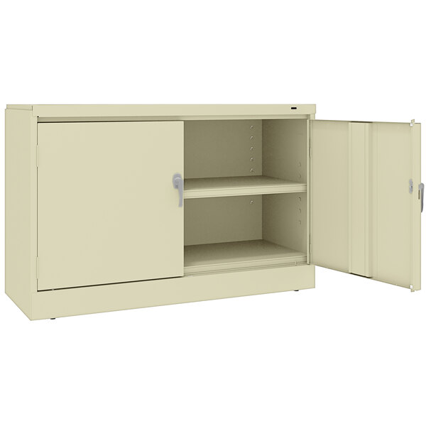 A white Tennsco jumbo storage cabinet with open doors.