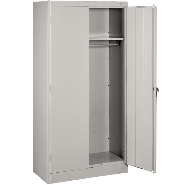 A light gray Tennsco metal cabinet with solid doors open.