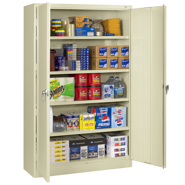 A Tennsco putty industrial storage cabinet with many items on the shelves.