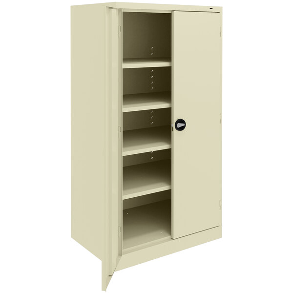 A beige Tennsco metal storage cabinet with solid doors and shelves.
