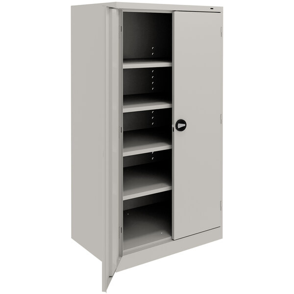A light gray Tennsco storage cabinet with shelves and solid doors.