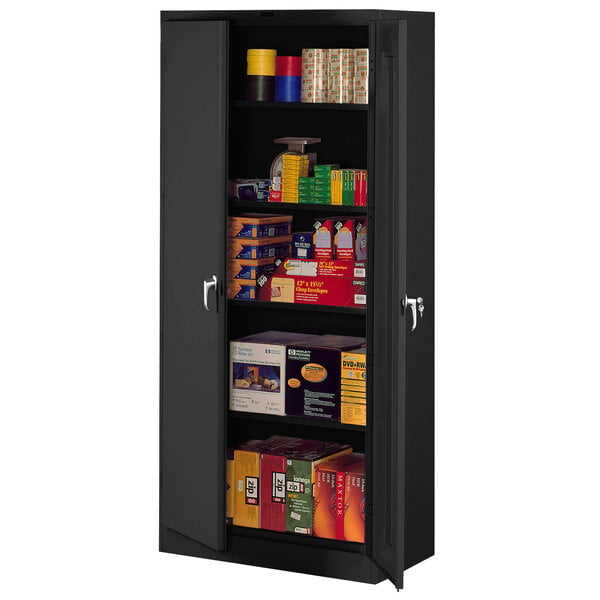 A black metal Tennsco deluxe storage cabinet with shelves full of products.
