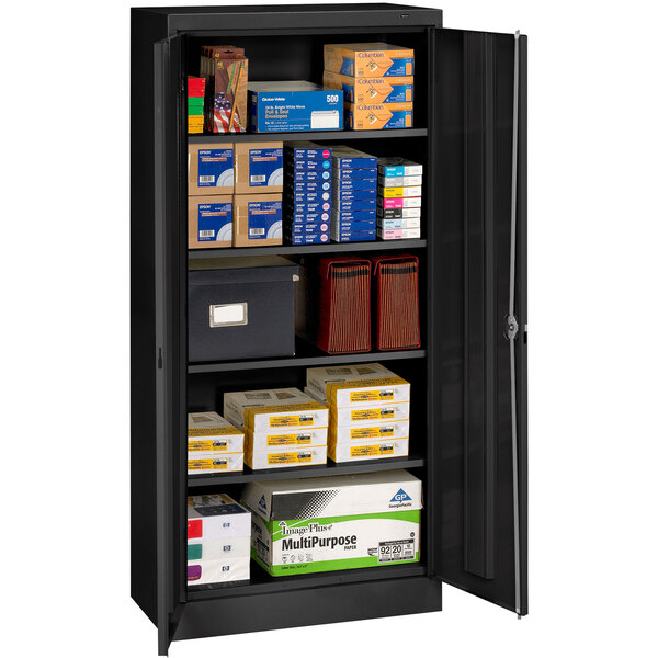 A black Tennsco storage cabinet with solid doors on a black background.