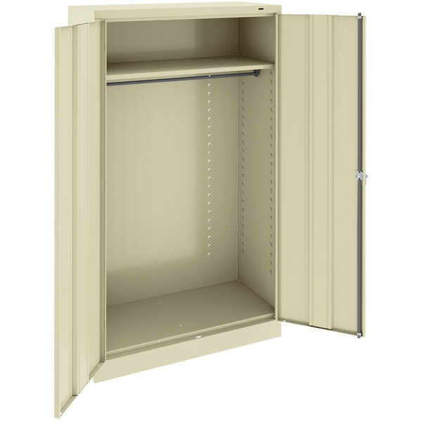 A tan metal Tennsco wardrobe cabinet with open solid doors.