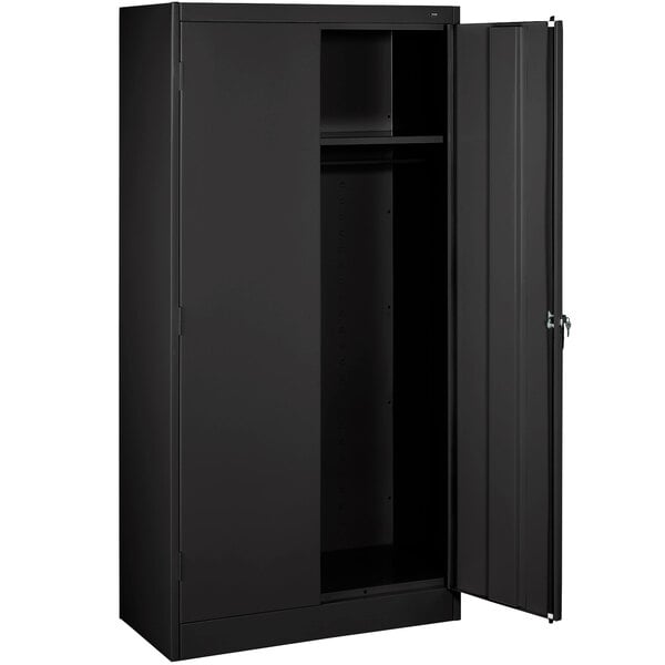 A black metal Tennsco wardrobe cabinet with solid doors.