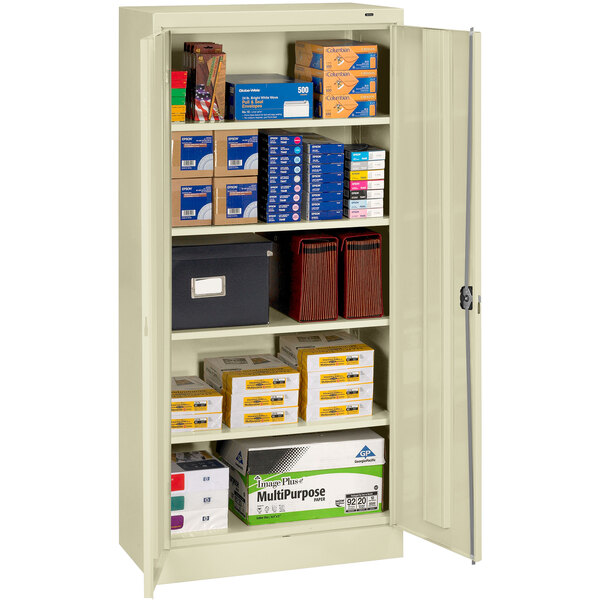A Tennsco putty storage cabinet with many boxes and files inside.
