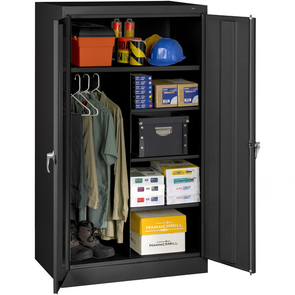 A black metal Tennsco standard combination cabinet with solid doors filled with various items.