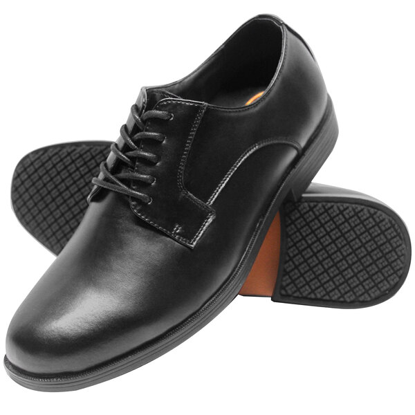 A pair of black Genuine Grip water-resistant leather oxford shoes with rubber soles.