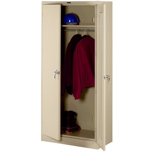 A beige metal Tennsco wardrobe cabinet with solid doors.
