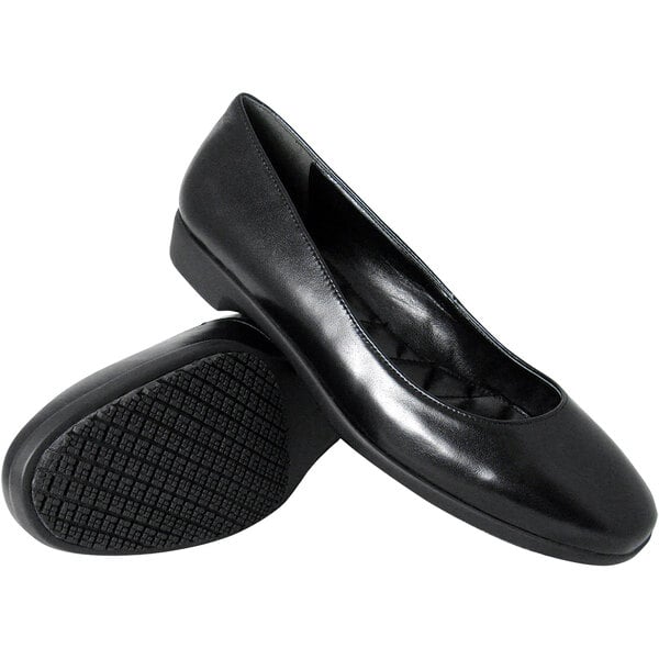 A pair of Genuine Grip black leather dress shoes with a rubber sole.