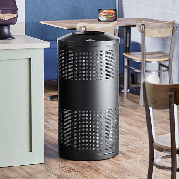 A black Lancaster Table & Seating trash can in a room.