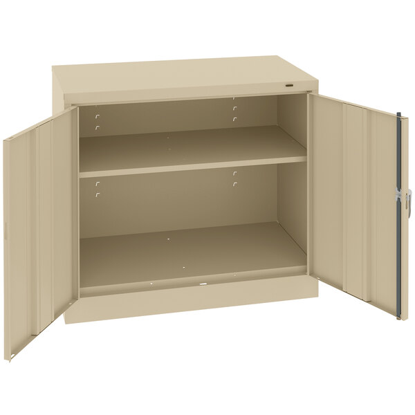 A tan Tennsco metal storage cabinet with open solid doors.