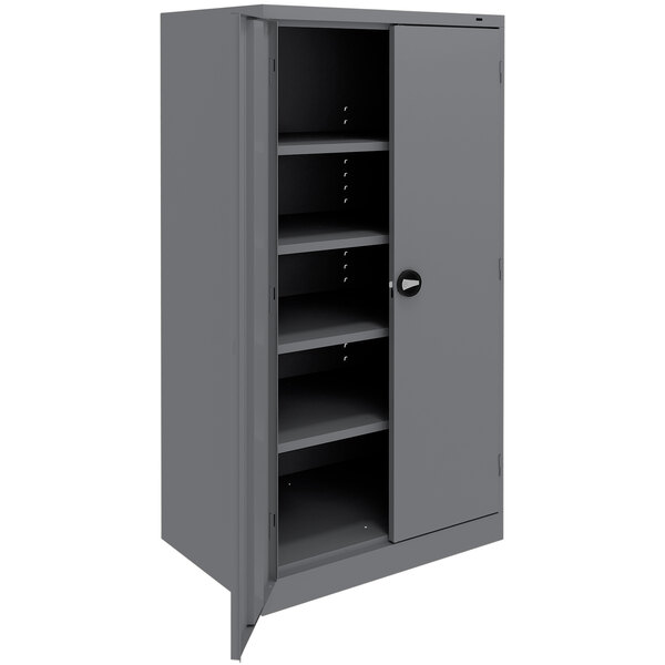 A dark gray metal Tennsco storage cabinet with solid doors and shelves.