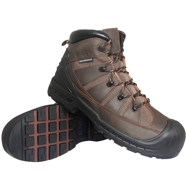 A pair of brown Genuine Grip safety boots with black laces and a black sole.