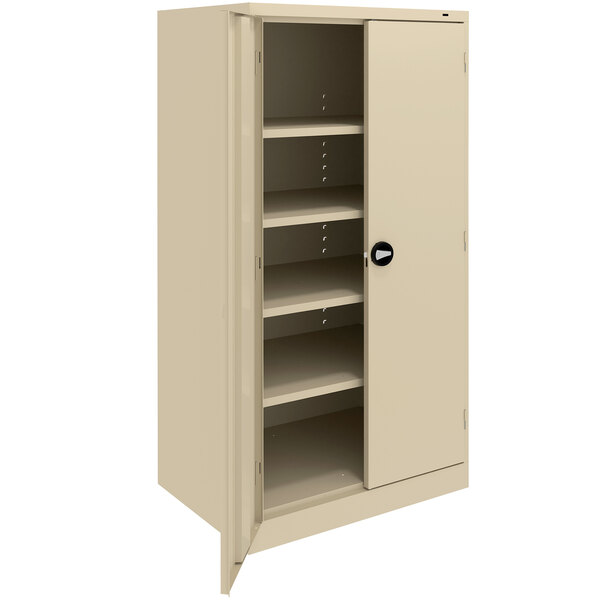 A tan metal Tennsco storage cabinet with shelves and solid doors.