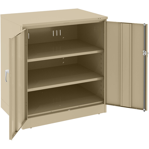 A tan Tennsco metal storage cabinet with open doors.