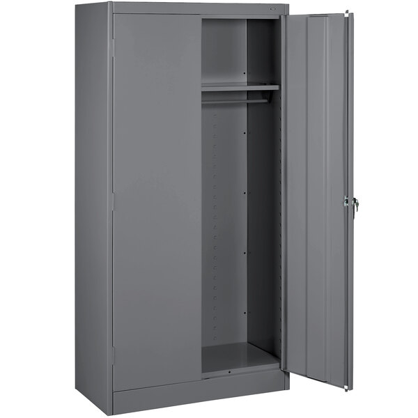 A grey metal Tennsco wardrobe cabinet with solid doors.
