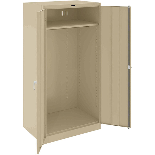 A tan metal Tennsco wardrobe cabinet with open doors.