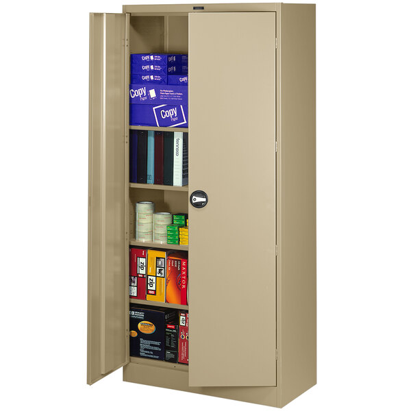 A tan metal Tennsco storage cabinet with solid doors filled with books.