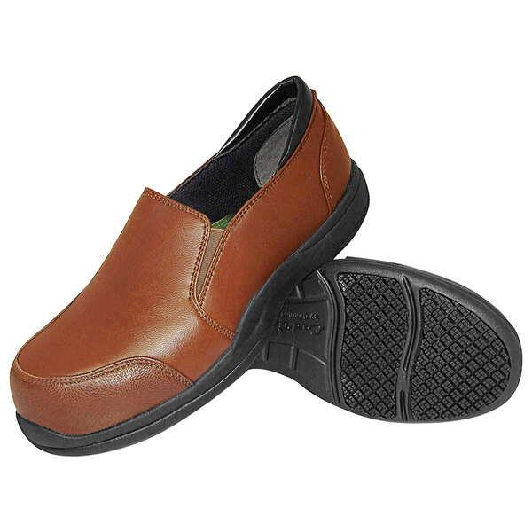 A pair of caramel brown Genuine Grip women's work shoes with a black sole.