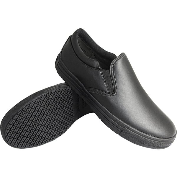 A pair of men's Genuine Grip black slip-on shoes with rubber soles.
