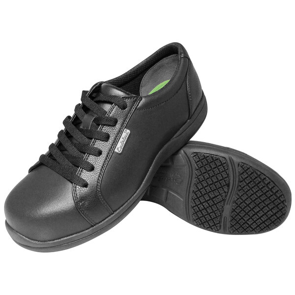 A pair of black Genuine Grip women's shoes with laces.