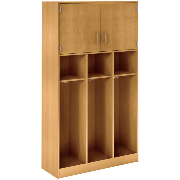 A maple wooden locker with three doors and adjustable middle shelves.