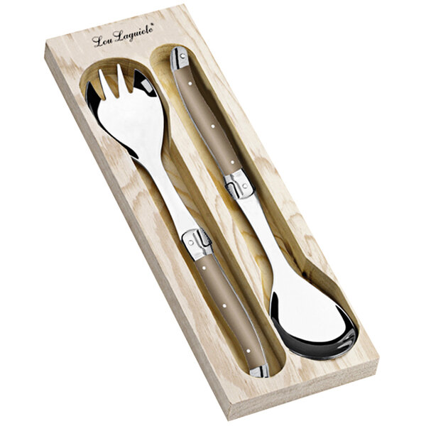 A Lou Laguiole taupe salad serving utensil set in a wooden case with a spoon and fork.