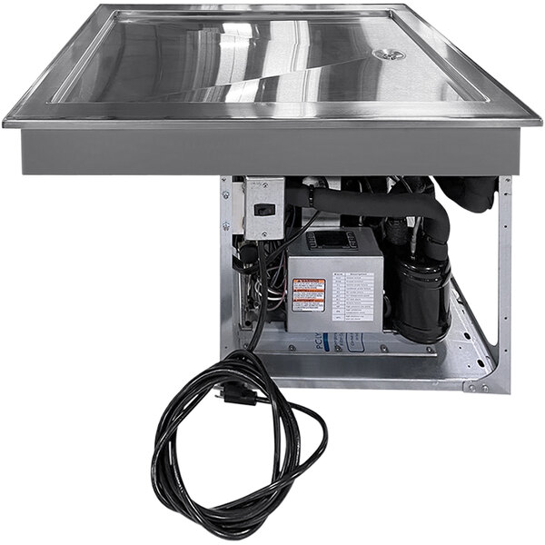 A LTI drop-in frost top machine with a glass top on a counter.