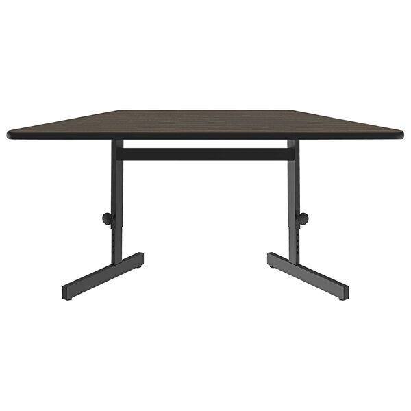 A Correll trapezoid computer and training table with a black base.
