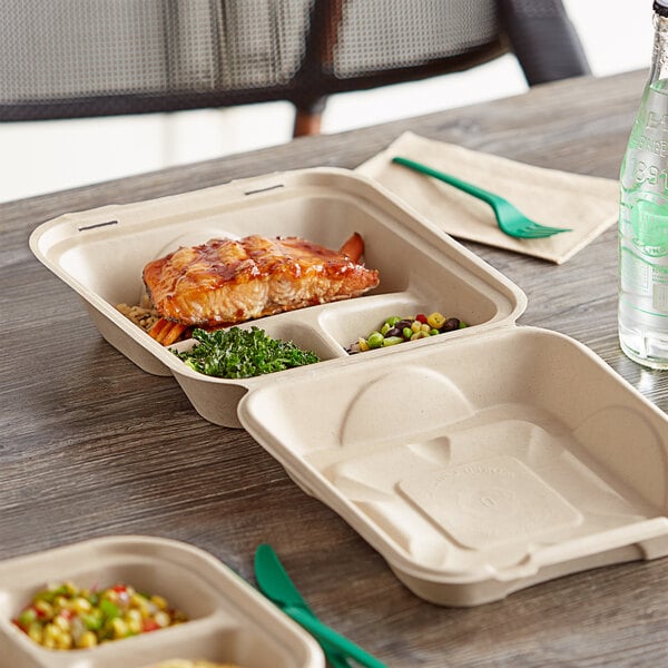 A white World Centric 3-compartment take out container filled with food on a table.