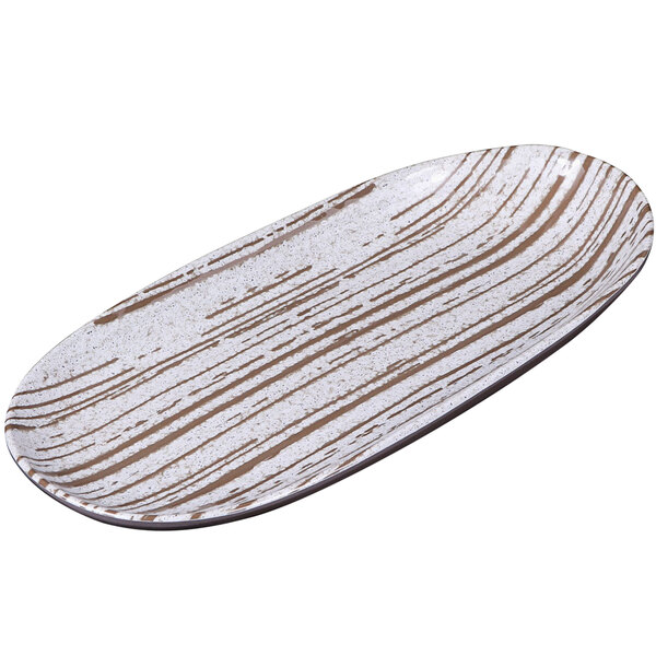 An oval white melamine plate with a white and brown swirl pattern.