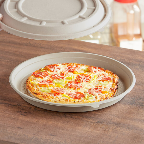 A pizza in a World Centric round fiber pizza container.