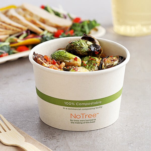 A white World Centric compostable paper food cup filled with food.