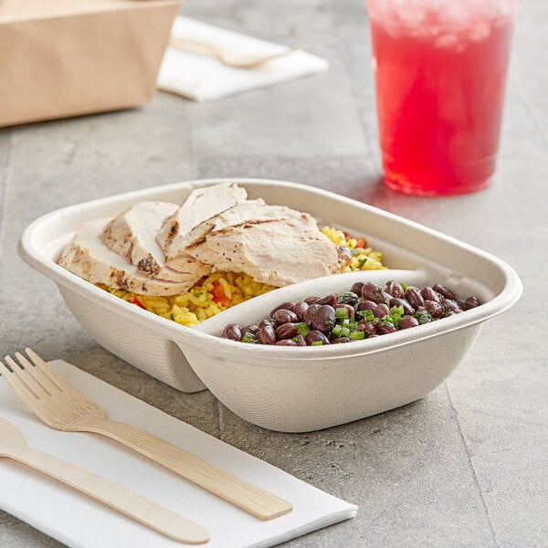 A World Centric eco-friendly compostable container with rice, beans, and chicken in it.