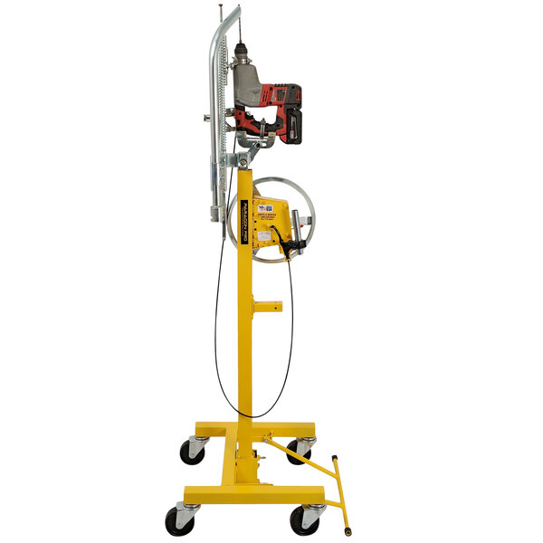 A yellow and white Paragon Pro Manufacturing Solutions Drillrite overhead concrete drill press stand with a drill and a cord.