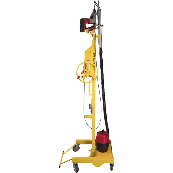 A yellow and red Paragon Pro Manufacturing Solutions Drillrite overhead drill press on a stand with a red and black cylinder.