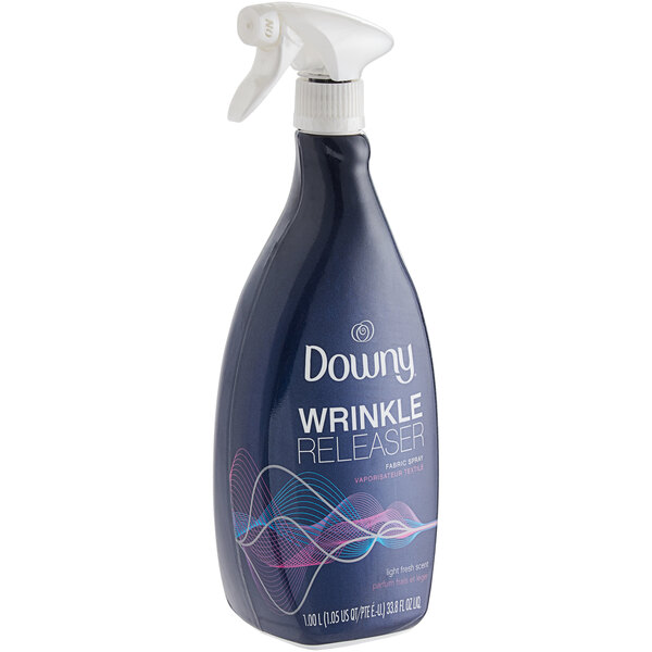 A blue and white Downy Wrinkle Releaser spray bottle.