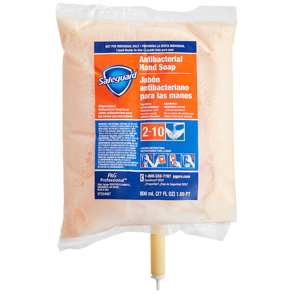 A Safeguard Professional plastic bag of orange liquid hand soap with a blue and white label.