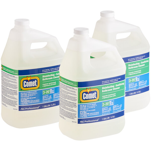 Three Comet disinfectant cleaner jugs on a counter.