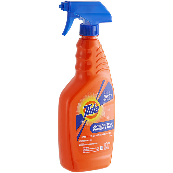 A Tide Antibacterial Fabric Spray bottle with a blue handle.