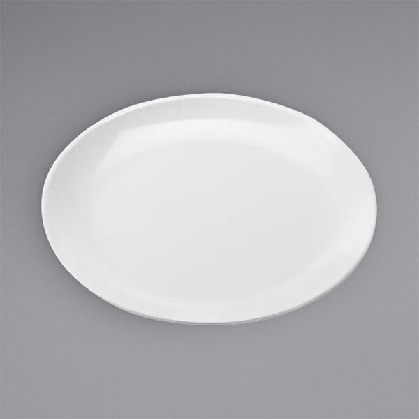 An American Metalcraft white melamine pizza plate on a gray surface.