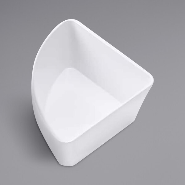 An American Metalcraft white plastic quarter round serving bowl on a gray surface.