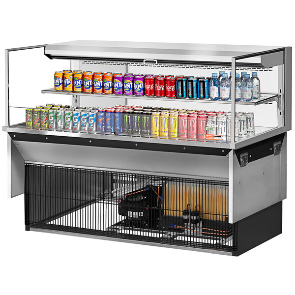 A Turbo Air refrigerated display case with cans of soda on a shelf.