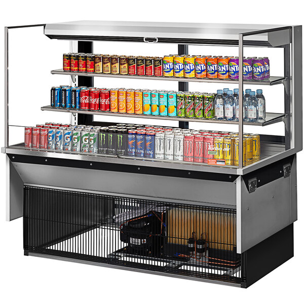 A Turbo Air drop-in refrigerated open display case with drinks and cans on shelves.