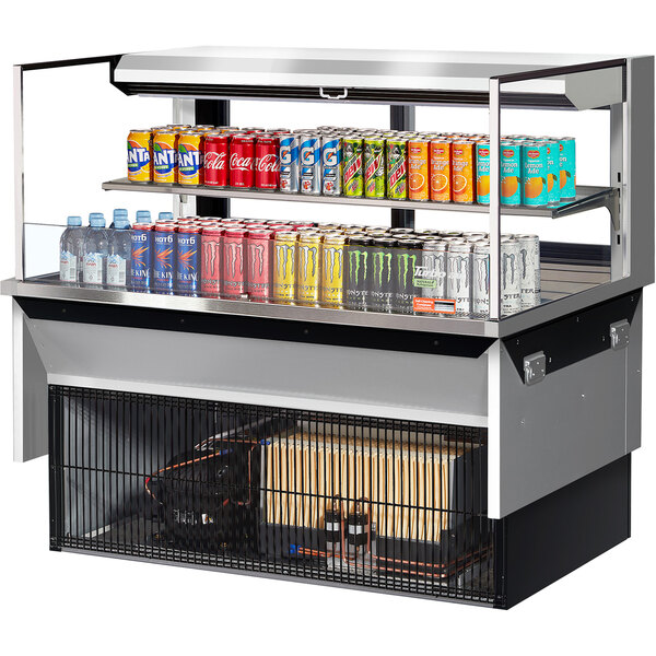A Turbo Air drop-in refrigerated display case with a variety of canned drinks on a shelf.
