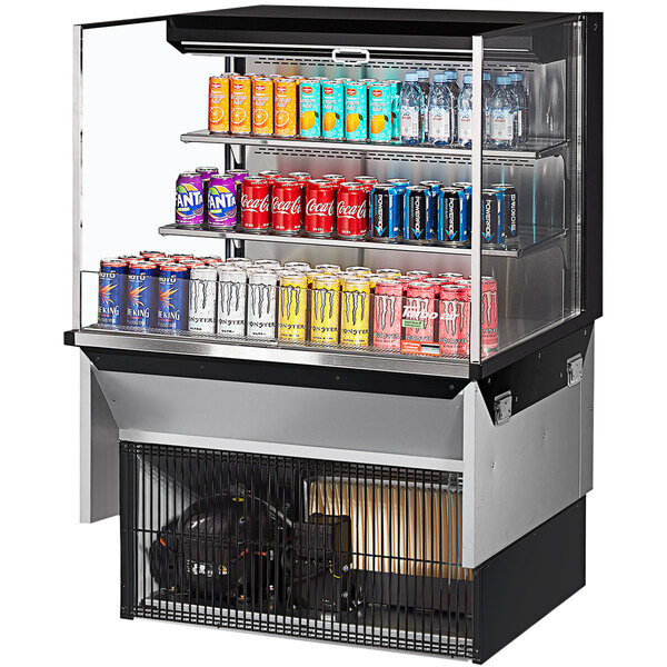 A black Turbo Air drop-in refrigerated display case filled with drinks and cans on shelves.
